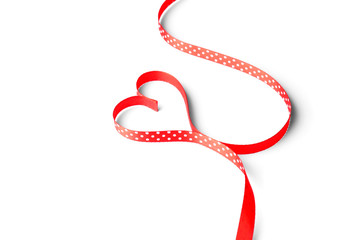 Heart made of satin ribbon on white background