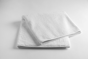 Folded soft terry towel on light background