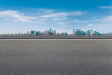 Foreground highway asphalt pavement city building commercial building office building