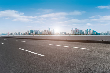 Foreground highway asphalt pavement city building commercial building office building