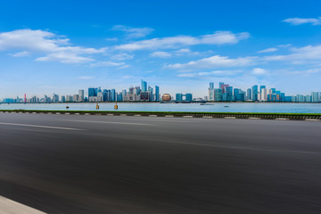 Obraz premium Foreground highway asphalt pavement city building commercial building office building