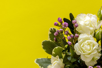 Festive flower composition on the yellow background. Flat lay style, place for text. Top view and Close-up. Holiday concept. Spectacular background pastel.