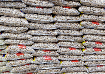 Grocery store shelves stacked with bags of pinto beans.