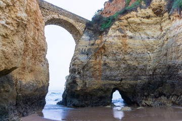 Fototapeta na wymiar Beach in Lagos, Portugal with rock bridge