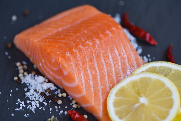 Fresh salmon fillet on dark background
