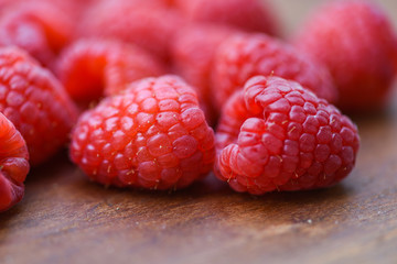 Fresh raspberry on wooden / Close up red ripe raspberries fruit