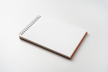 perspective view of spiral orange notebook