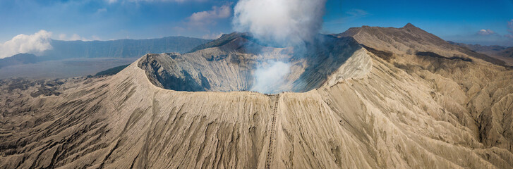 Beautiful panorama view of Mount Bromo volcano in East Java of Indonesia. An iconic most popular tourist attraction in Java island. - obrazy, fototapety, plakaty