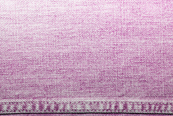 Shabby denim texture for background. Pink jeans 