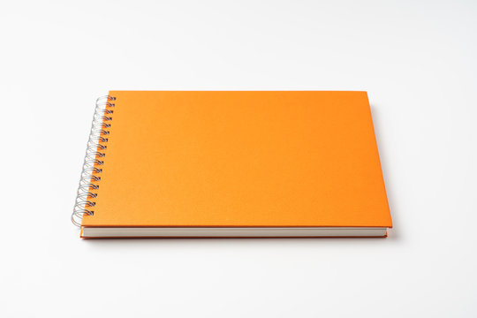 perspective view of spiral orange notebook