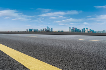 Foreground highway asphalt pavement city building commercial building office building