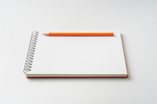 perspective view of spiral orange notebook