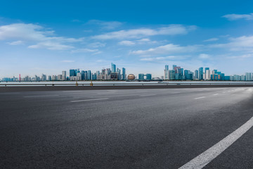 Foreground highway asphalt pavement city building commercial building office building