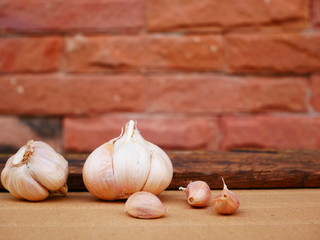 garlic and onion on wooden board