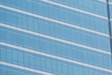 Fototapeta na wymiar Modern office building with blue glass windows