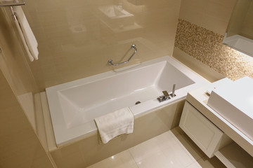 White and light brown bathroom interior with white bathtub in Luxury bathroom.