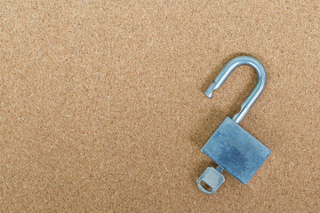Old master key and key lock on cork board