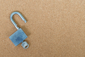 Old master key and key lock on cork board