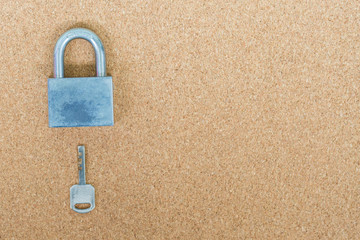 Old master key and key lock on cork board