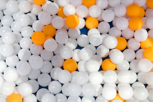 Ping pong balls mix of orange and white balls on a blue table background