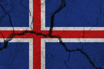 Fototapeta premium Iceland flag on the cracked earth