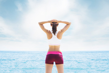 Young and sporty woman training in outdoor gym. Fitness, sport and health care.