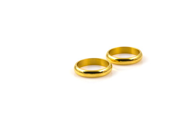 Close up of two gold rings for wedding isolated on white