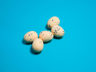 Quail eggs on a blue background