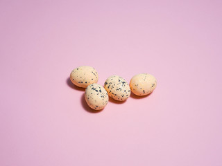 Quail eggs on a pink background.
