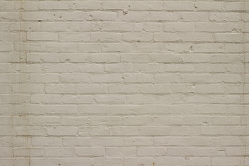 Grungy old white painted brick wall background showing deterioration and stains