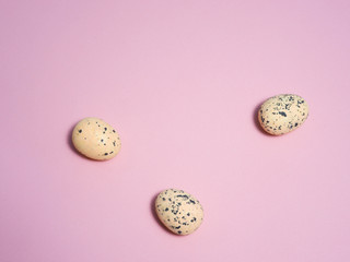 Quail eggs on a pink background.