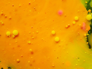 Bubbles on yellow orange background. Close up macro shot. Blurred background. Selective soft focus. Paint splashes and spots, abstract background. Pattern of abstract universe