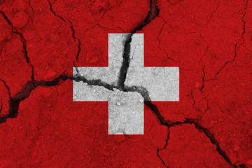 Switzerland flag on the cracked earth