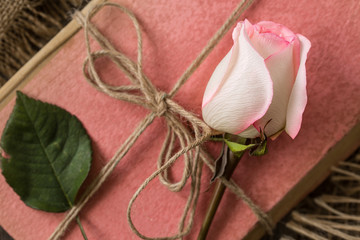 Pink rose on an old book in a vintage style