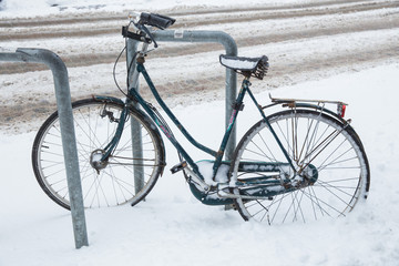 Bicycle at street and many snow. Urban photo 2019.
