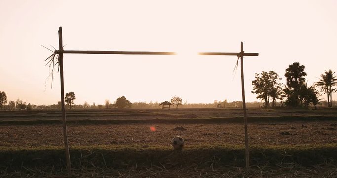 Old Football Or Soccer Ball On The field,Traditional football field during sunset,Old soccer ball and field