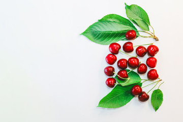 berries and leaves of cherry on a white background.