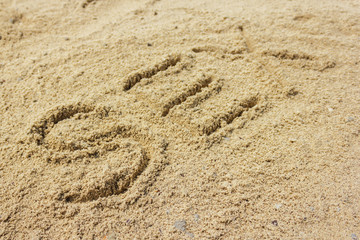 Fototapeta na wymiar Sex word written on the sand at the beach, natural background