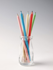colorful pencils in a glass bottle.