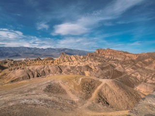 Fototapeta na wymiar Picturesque Soft Waves From Multi-Coloured Sandstone. Death Valley, Zabriski