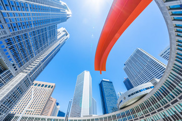 Obraz na płótnie Canvas Asia Business concept for real estate and corporate construction - looking up view of panoramic modern city skyline with blue sky in shinjuku, tokyo, japan