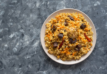 Lamb pilaf on a big plate. Asian traditional dish.