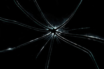 broken cracked glass with hole in black background