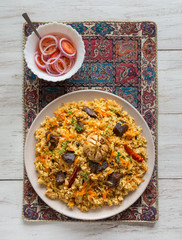 Lamb pilaf on a big plate. Asian traditional dish.