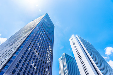 Obraz na płótnie Canvas Asia Business concept for real estate and corporate construction - looking up view of panoramic modern city skyline with blue sky in shinjuku, tokyo, japan