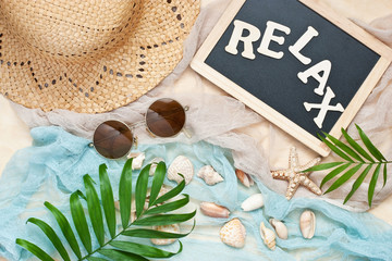 Beach items with accessories  on sand summer background