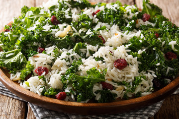 Fresh kale cabbage with boiled basmati rice and dried cranberries close-up on a plate. horizontal
