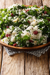 Delicious healthy kale cabbage with basmati rice and cranberries close-up on a plate. vertical