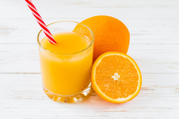 Fresh orange juice on white wooden background. Summer vitamin drinks