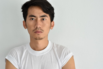 Young Asian man close up shot isolated on white